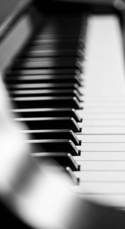A close-up view of a piano keyboard in black and white