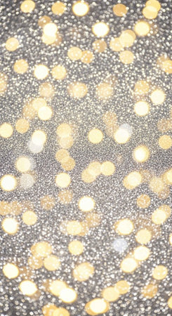 A close-up view of a sparkling silver and gold glitter background