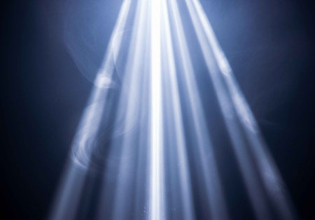 A bright beam of light shining through a dark spaceの写真素材