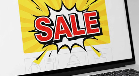 A laptop screen displaying a vibrant sale advertisement with a yellow background
