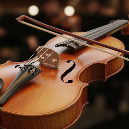 A close-up of a violin with a bow resting on its strings in a dark room.