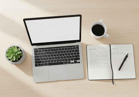 A modern workspace with laptop, notebook, and coffee on a wooden desk