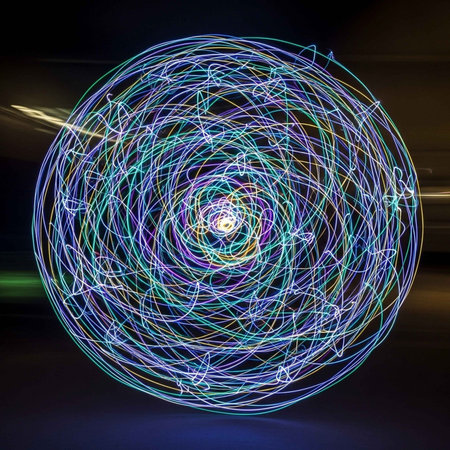A dynamic light painting featuring a circular pattern of glowing, colorful lines.