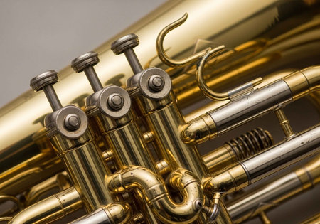 Detailed view of a brass trumpet's valves, tubing, and mechanical parts.の写真素材