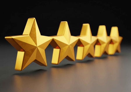 A row of shiny golden stars on a dark background for rating or review