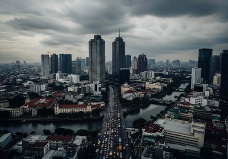 Aerial view of a bustling cityscape with a river running through it on a cloudy day