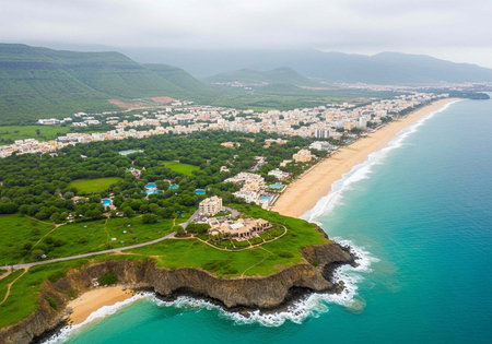 Aerial view of a coastal town with a sandy beach and green landscapeの写真素材
