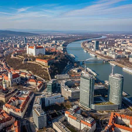 Aerial view of a modern cityscape with a river and blue sky