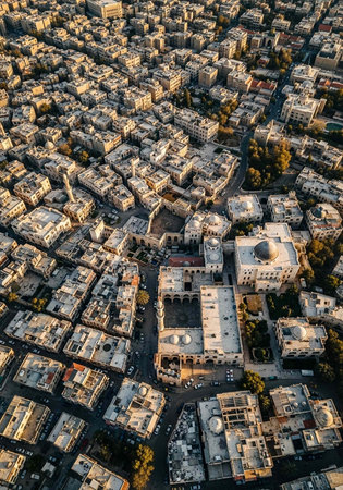 An aerial view of a densely populated city with white buildings and trees