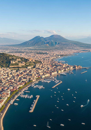 Aerial view of a coastal city with a large mountain in the backgroundの写真素材