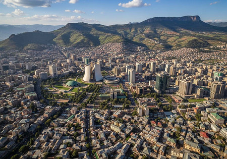 Aerial view of a vibrant city nestled between mountains and modern architecture