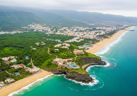 Aerial view of a coastal resort town with sandy beach and turquoise ocean waterの写真素材