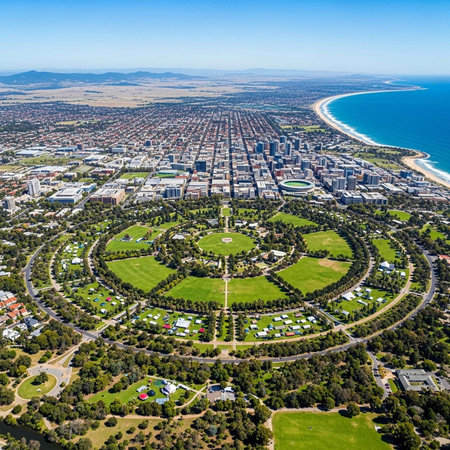 Aerial view of a coastal city with a large circular park and green spacesの写真素材