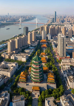 Aerial view of a vibrant cityscape with a pagoda and modern skyscrapers by a river