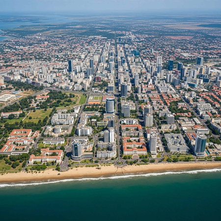 Aerial view of a modern coastal city with skyscrapers and beachfront properties