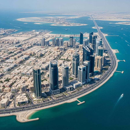 Aerial view of a modern cityscape with skyscrapers and waterfront along a vibrant oceanの写真素材
