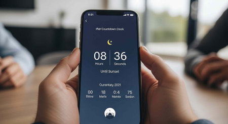A person holding a smartphone displaying a countdown timer on the screen indoors