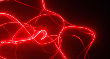 A vibrant red light trails against a dark background in a mesmerizing display