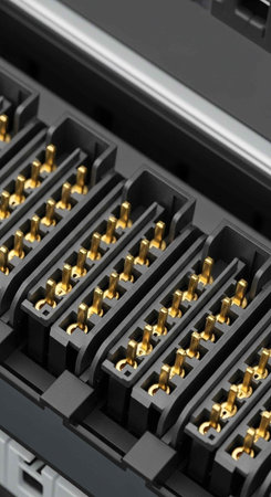 Detailed view of a black plastic tray containing gold connectors in rows of slots