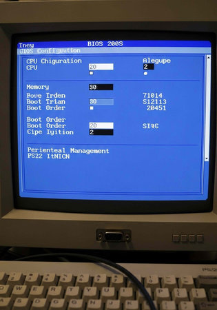 Close-up of a computer's BIOS setup screen on a monitor with a keyboard below