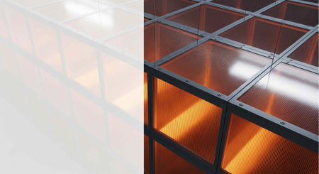 A modern glass ceiling with warm orange lighting and sleek metal framingの写真素材