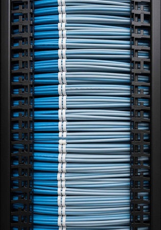 A close-up view of neatly organized network cables in a server rackの写真素材