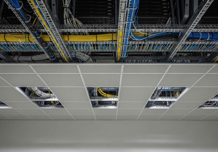 A modern data center with organized cable management and a clean ceiling