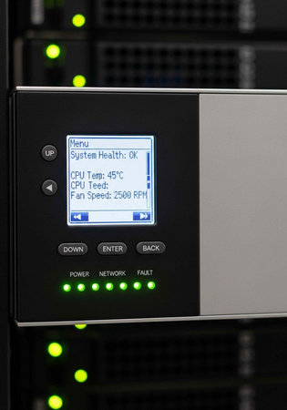 A close-up view of a computer server control panel with green lights