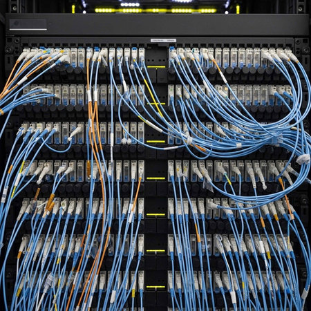 A complex network server with multiple cables and wires connected to it