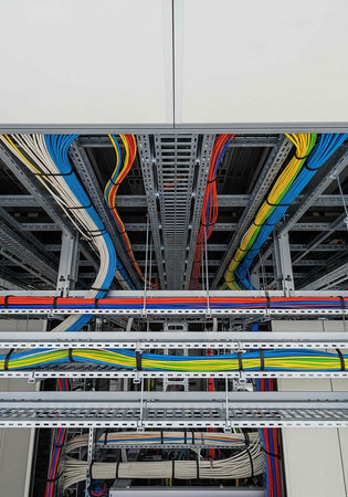 A complex network of colorful wires and cables in a modern data center infrastructure