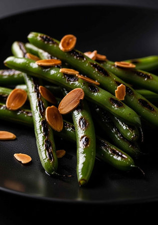 A plate of green beans with almonds on a black background
