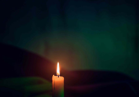 Burning candle on a dark background with a place for text.の写真素材