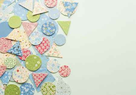 Colorful paper applique on white background with space for text.