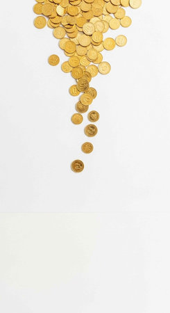 A large pile of gold coins spilling down on a white background