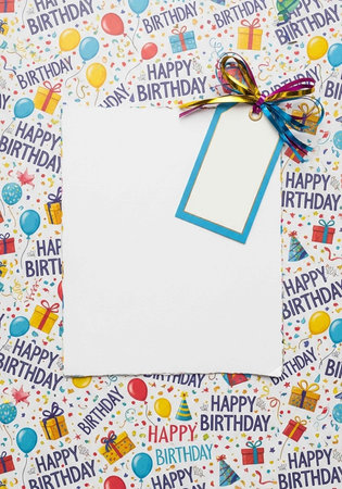 A colorful birthday card with a blank white tag and a rainbow ribbon on a festive background