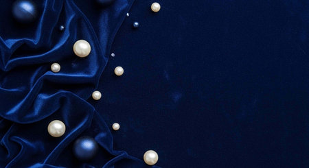A luxurious dark blue silk fabric with scattered pearls on a elegant backgroundの写真素材