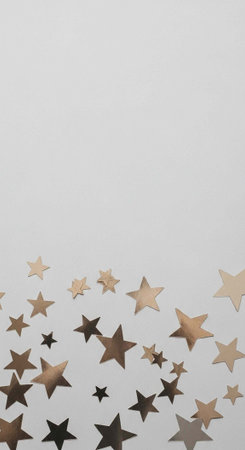 A festive arrangement of gold and silver stars on a white background for a celebratory decoration