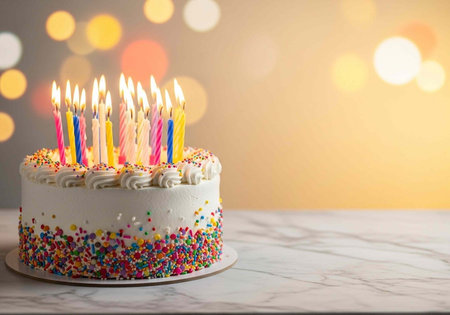 Birthday cake with burning candles on table against bokeh background