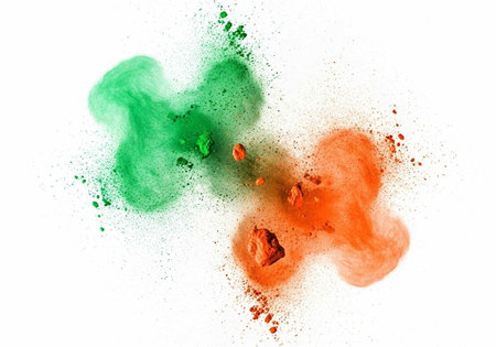 Colorful green and orange powder blasts against a clean white backdrop
