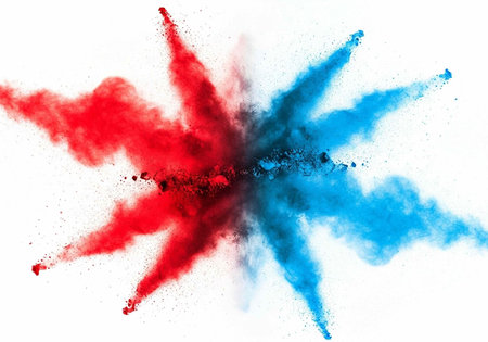 Colorful red and blue powder explodes in a dynamic, starburst pattern on a clean white surface.