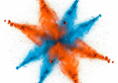 Colorful orange and blue powder exploding in star shape on white