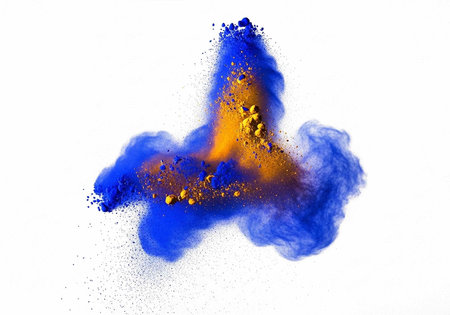 A vibrant cloud of blue and orange powder exploding in mid-air against a white background