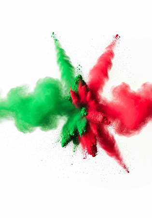 A vibrant explosion of red and green powder on a white background