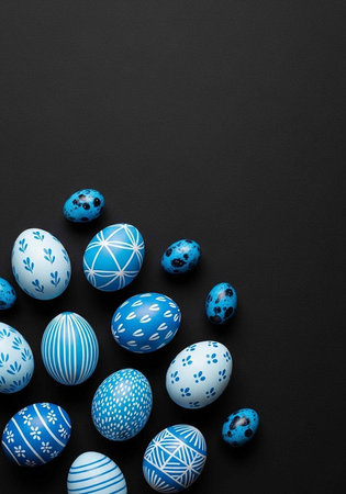 Collection of blue and white decorated Easter eggs on dark background, various patterns and designs