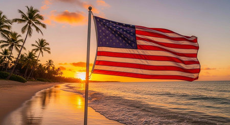 American flag waving on a beach at sunset with palm trees and calm ocean wavesの写真素材