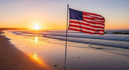 An American flag waves on a serene beach at sunset with vibrant colors in the sky