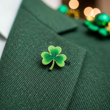 A green suit lapel with a small four-leaf clover pin for St. Patrick's Day celebration
