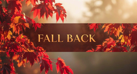 A vibrant autumn scene with red and orange leaves and the words Fall Back in the center