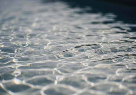 A serene and peaceful body of water with gentle ripples and sunlight reflections on its surfaceの写真素材