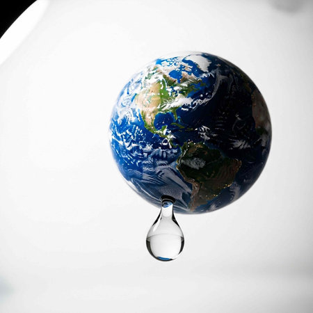 A globe with a drop of water symbolizing the importance of conservation and sustainability in...